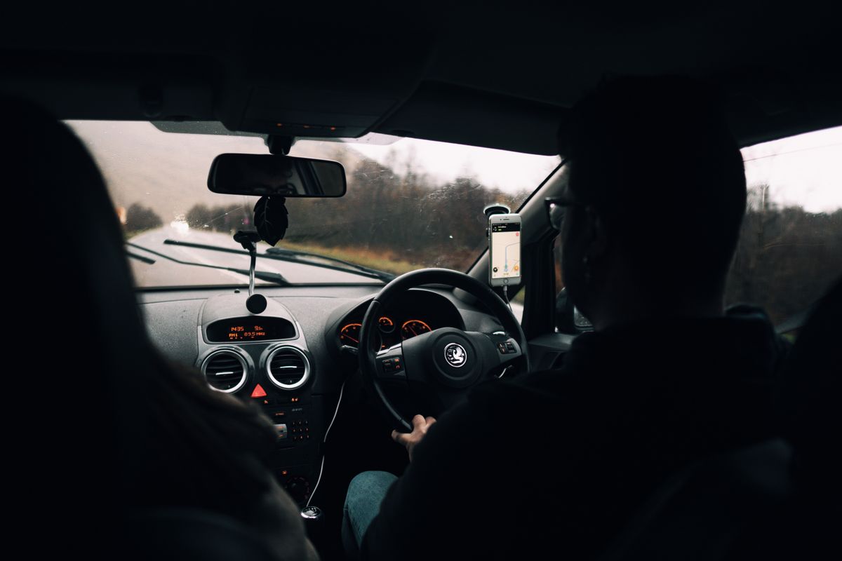 Man driving a car beside a woman