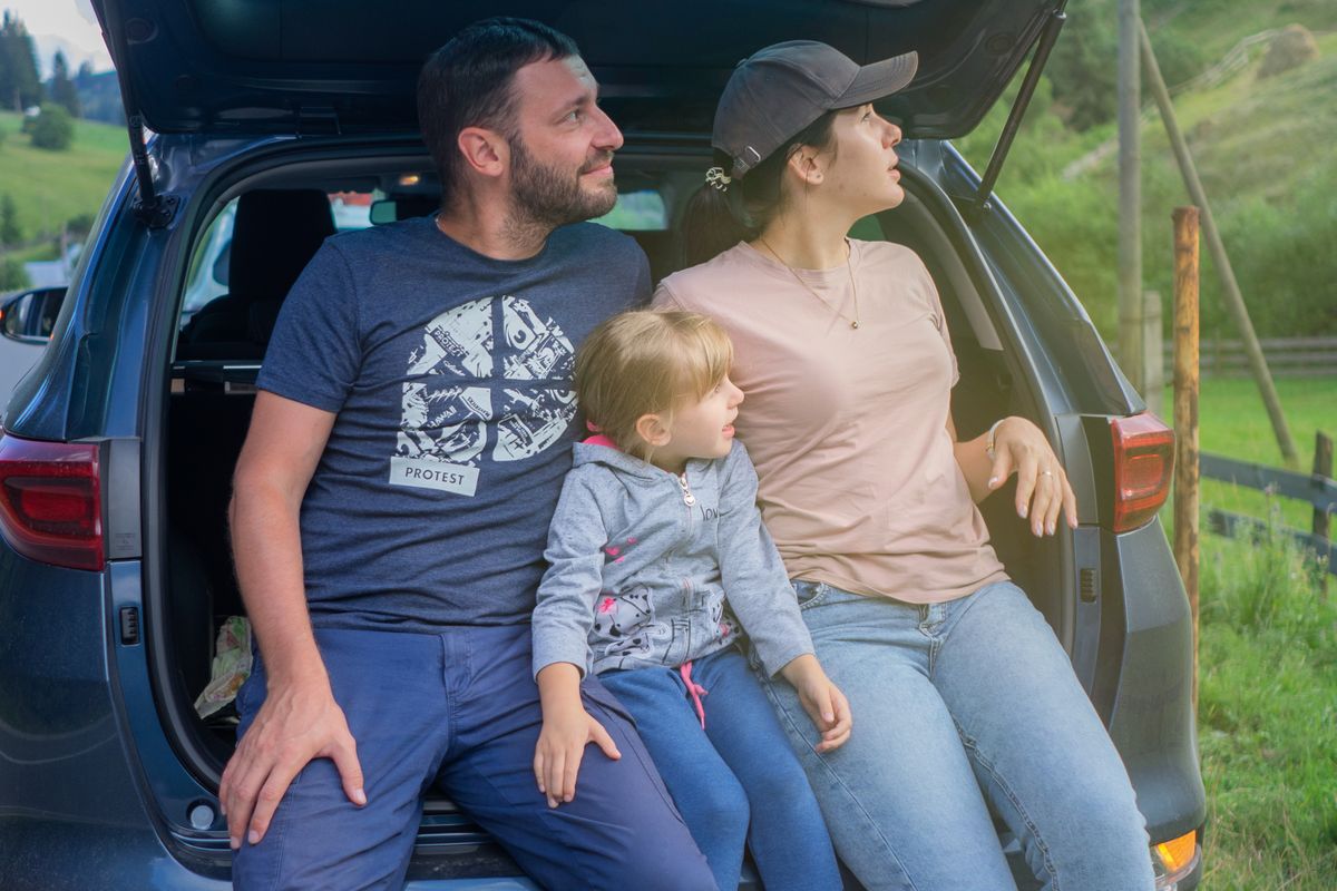 A family sits in a car trunk