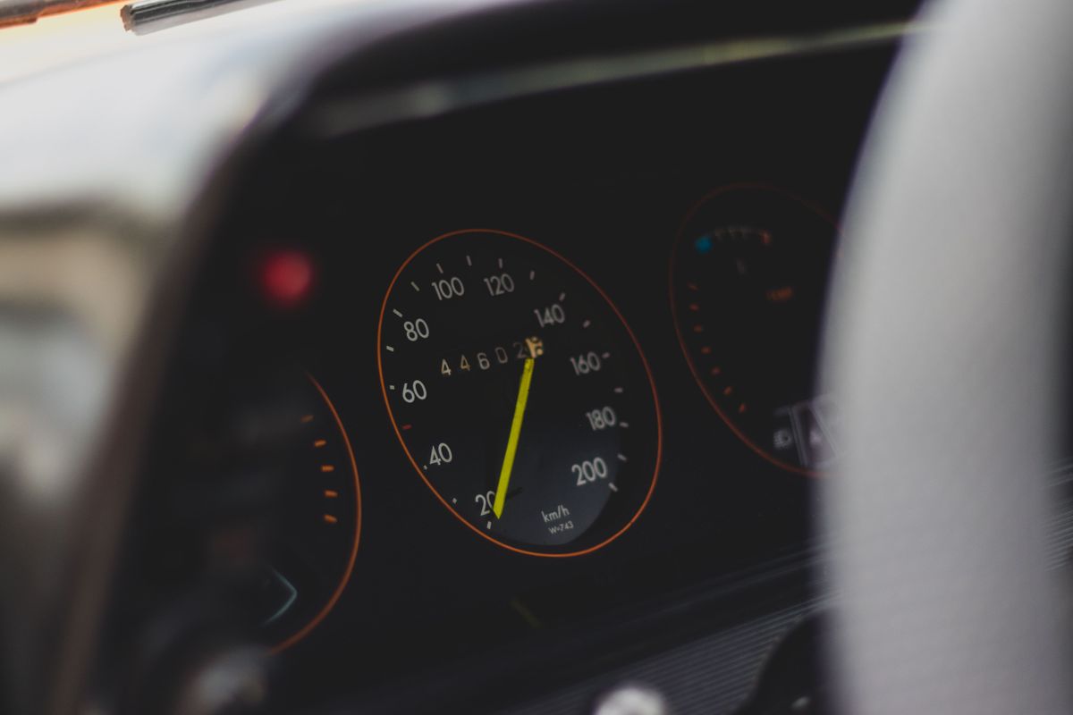 Detailed view of a car speedometer showing speed and mileage