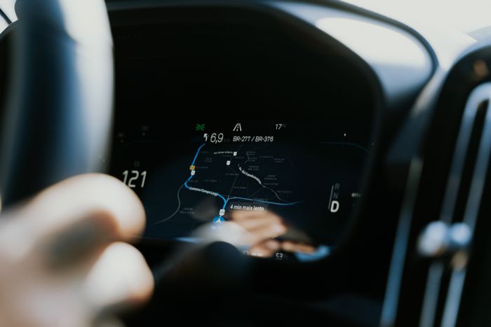 Close-up view of a car dashboard showing a GPS navigation screen in use
