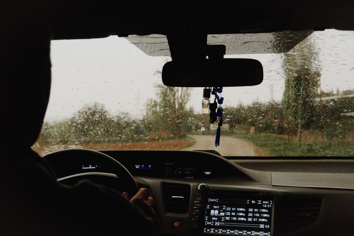 Driving through a scenic road in the rain