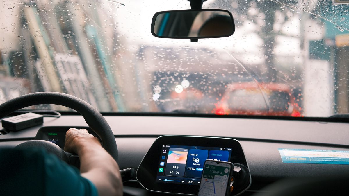 A man driving a car in the rain