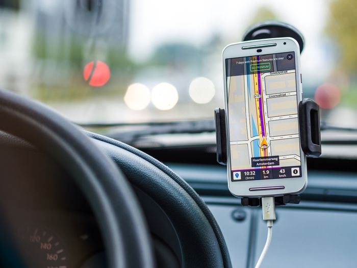 Smartphone mounted in car using GPS for navigation and directions