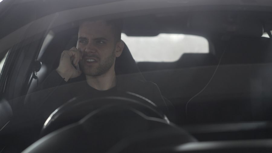 A driver talking on the phone inside his car