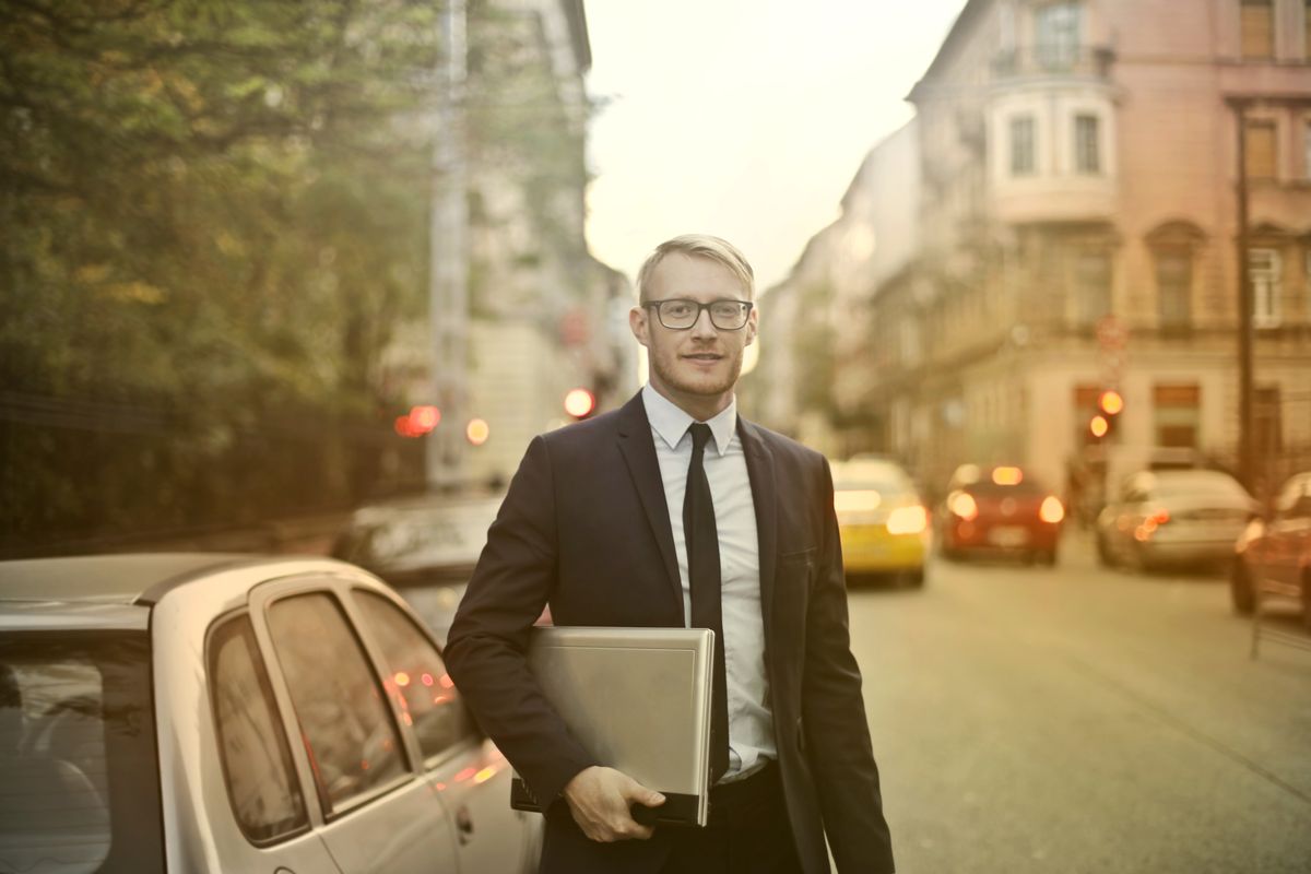 Confident well dressed male entrepreneur in elegant suit and eyeglasses