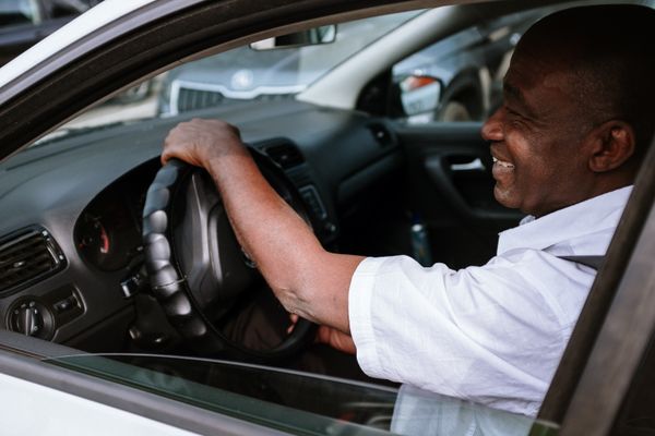 Smiling man in a car, enjoying a drive