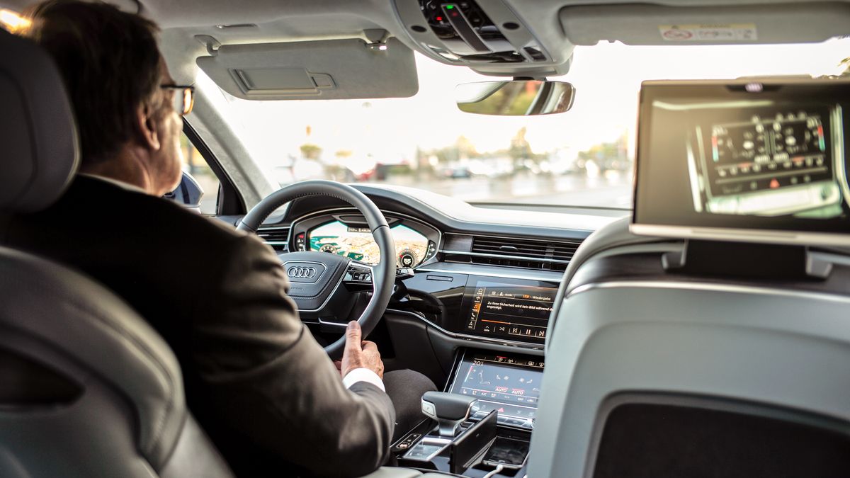 Person driving modern luxury car with dashboard visible