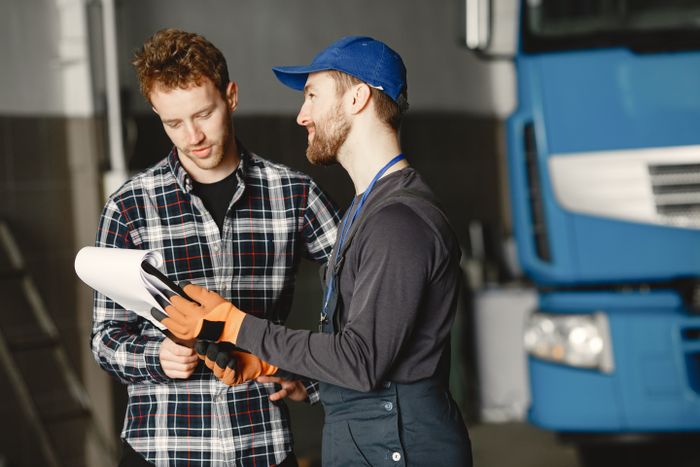 A mechanic consulting with a customer in the garage