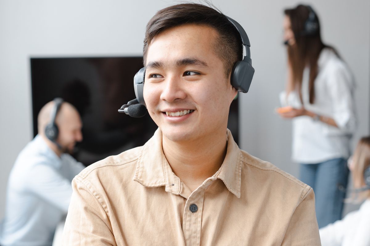 A confident call center agent wearing a headset