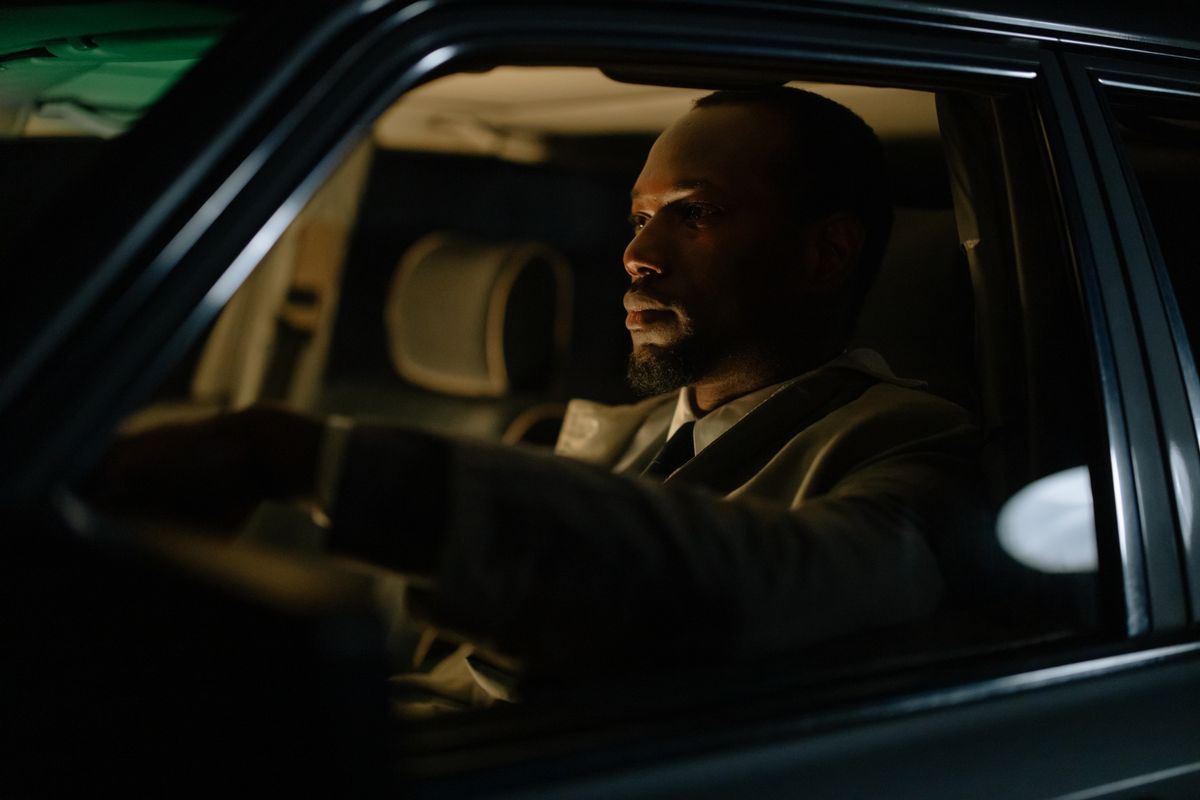 Focused man driving at night in vehicle